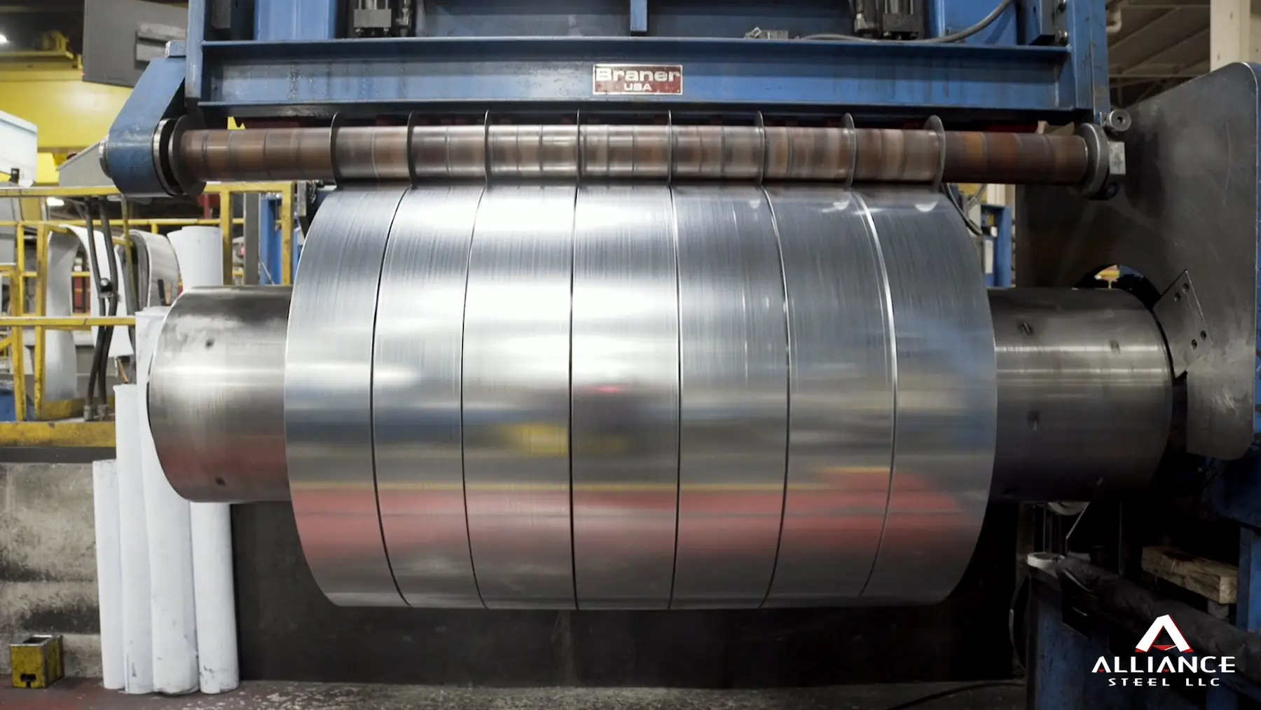 Slit steel coil being rewound on the recoiler of a slitting line