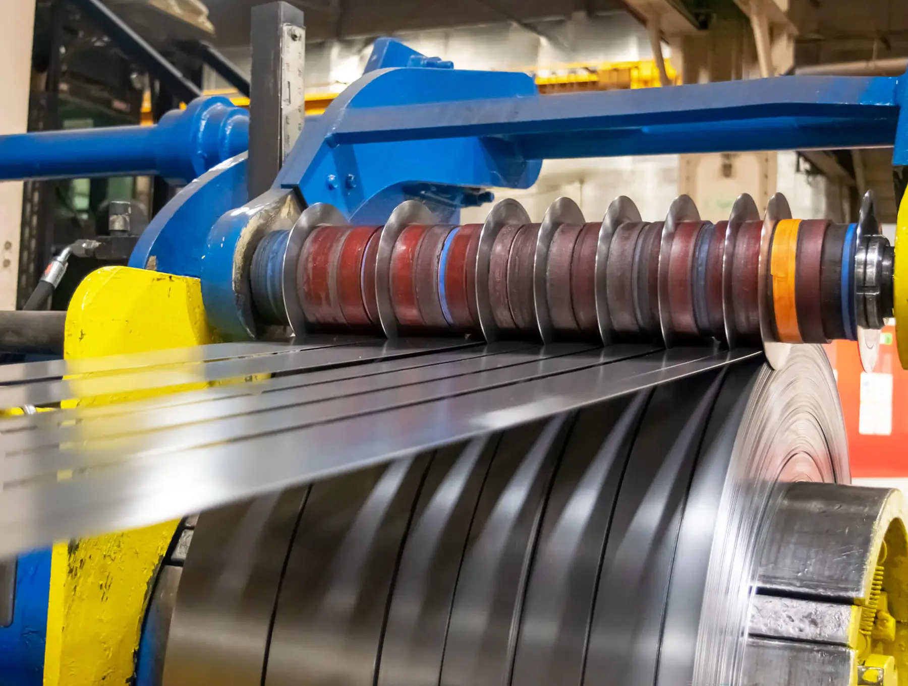 Slitter knives cutting steel strip into narrow mults on a slitting line