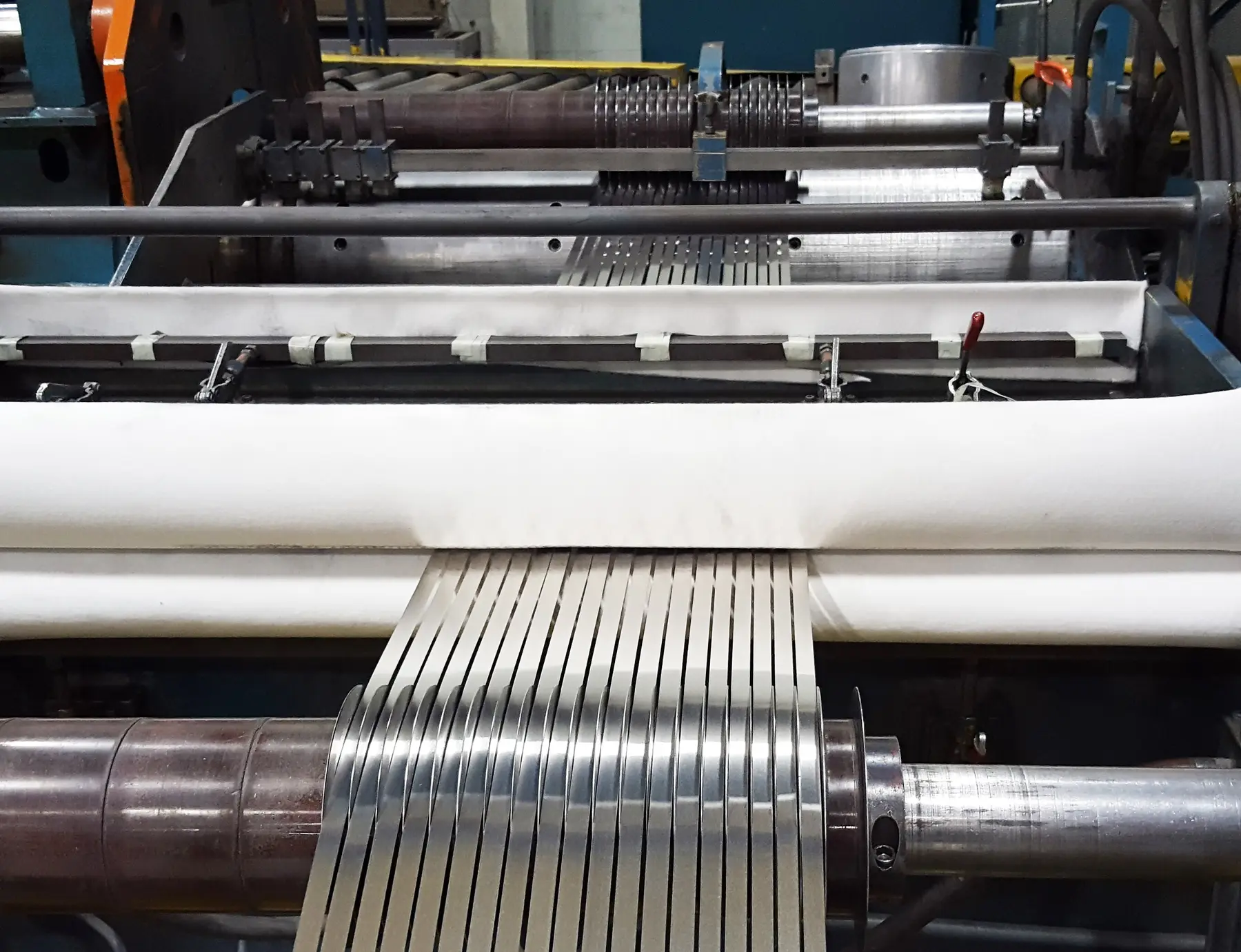 Almetals slitting line separating bright metal coil into narrow strands at the recoiler