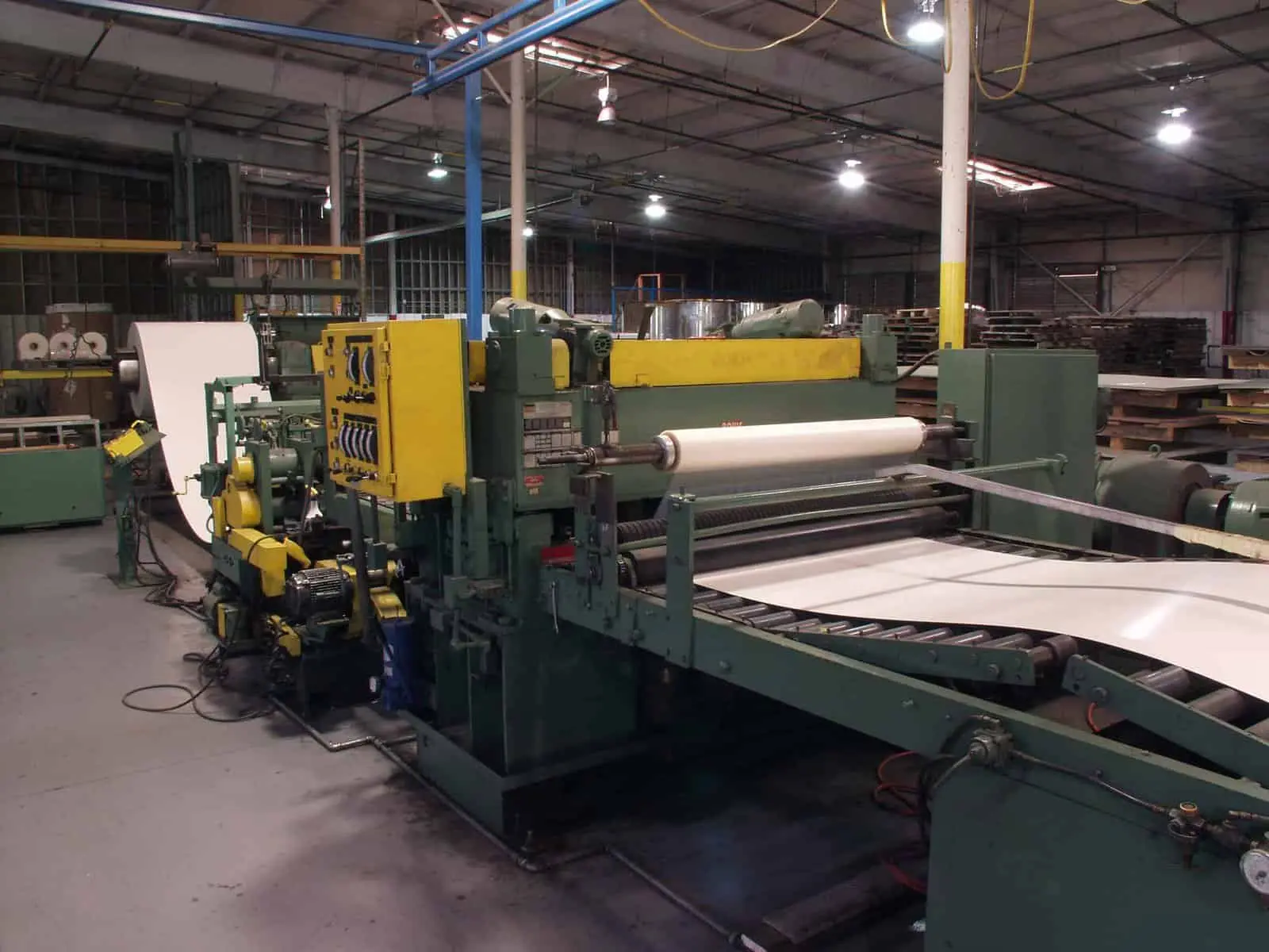 American Douglas Metals cut-to-length line running coated sheet from coil to stacker