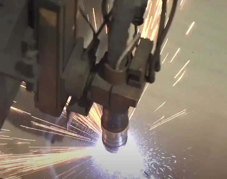 Hi-def plasma torch cutting metal plate with a shower of sparks at Arbor Metals
