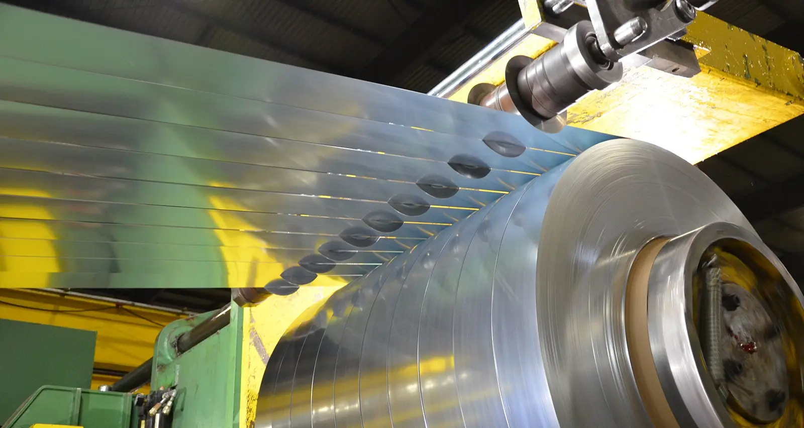 Slit steel strands winding onto the recoiler of an Arlington Metals slitting line