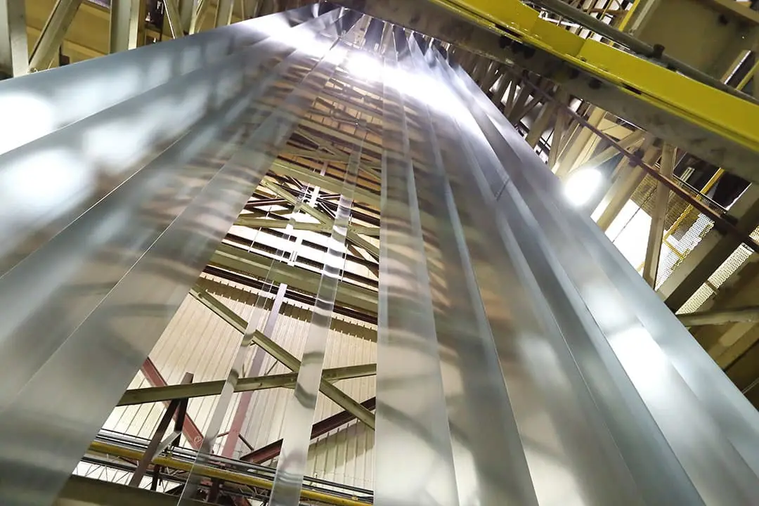 Metal strip running vertically through the coil coating line tower at AZZ Precoat Metals
