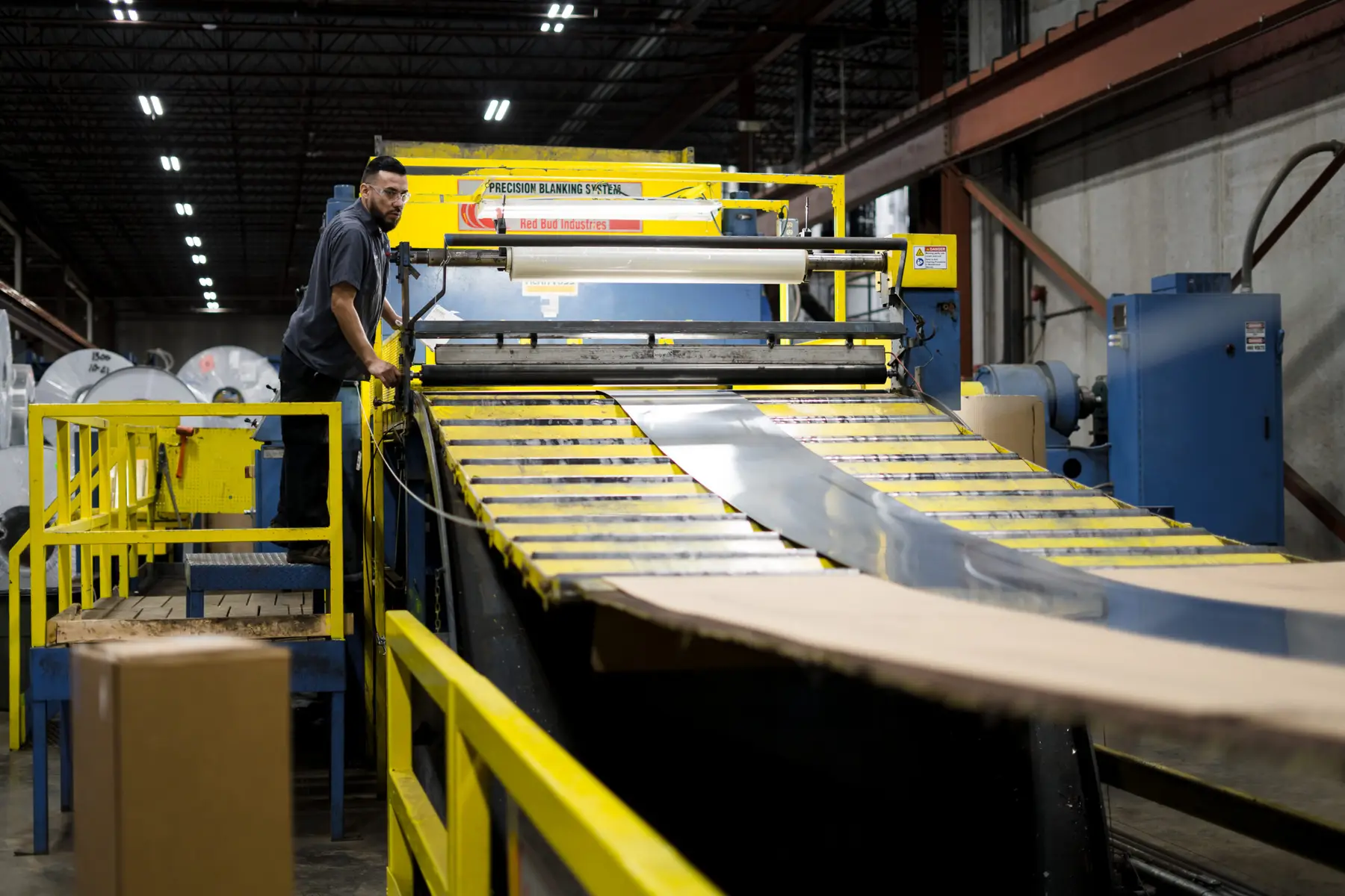 Metal strip running through a coil processing line at Basic Metals