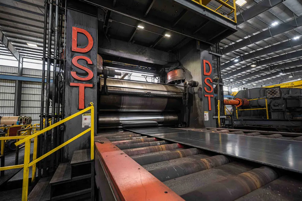 Beshert's temper mill stands feeding steel plate onto the roller table in the Houston plant
