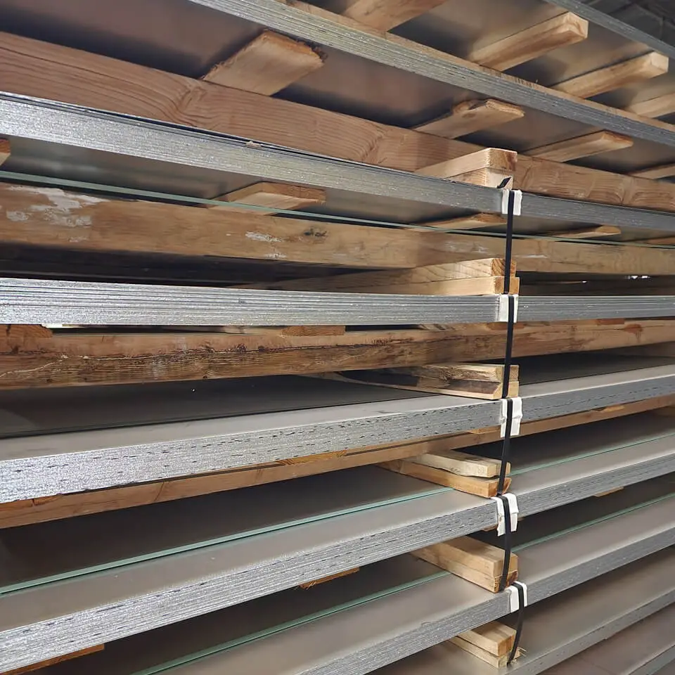 Stacks of cut steel sheet separated by wooden dunnage at Big O Metals