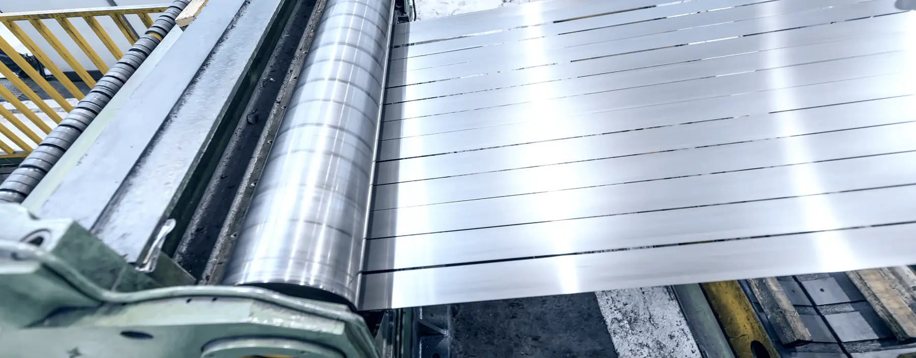 Bright steel strip being slit into multiple narrow mults on a slitting line