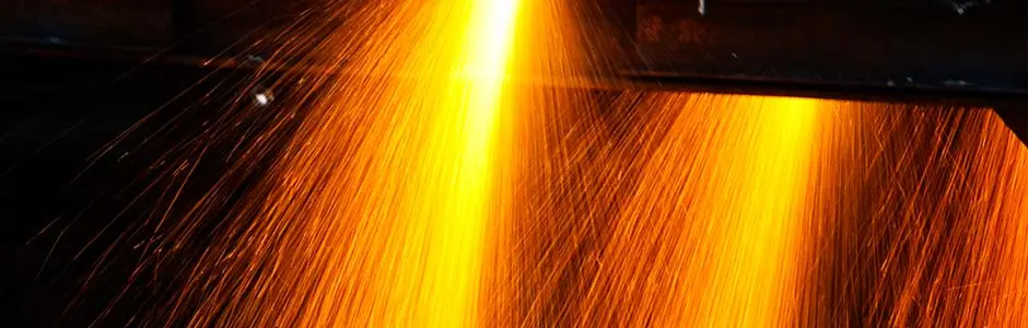 Sparks spraying from a cutting torch as it cuts through steel plate at Borrmann Metal Center
