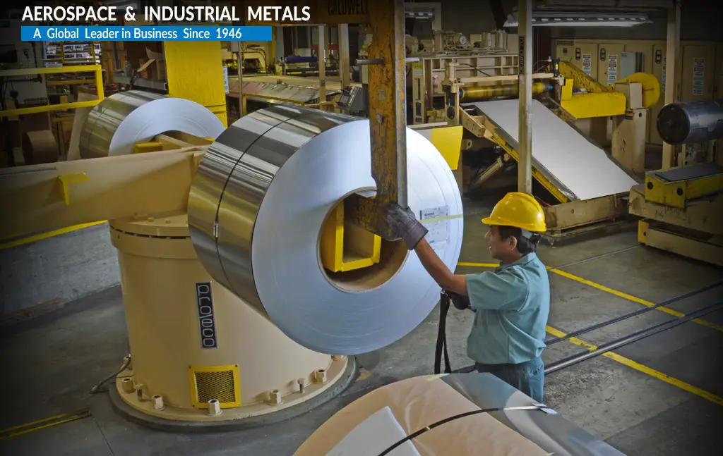 Aluminum coil being loaded onto the entry of a Bralco Metals leveling line