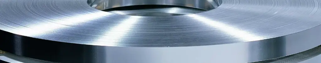 Close-up of a bright slit stainless steel coil wound on its edge
