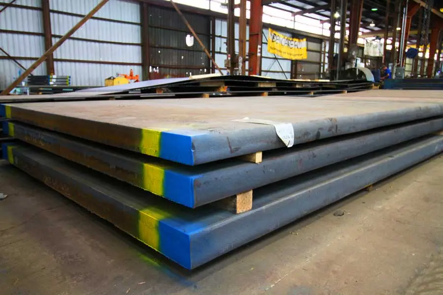 Color-coded high-strength weathering steel plates stacked in the Pelham warehouse
