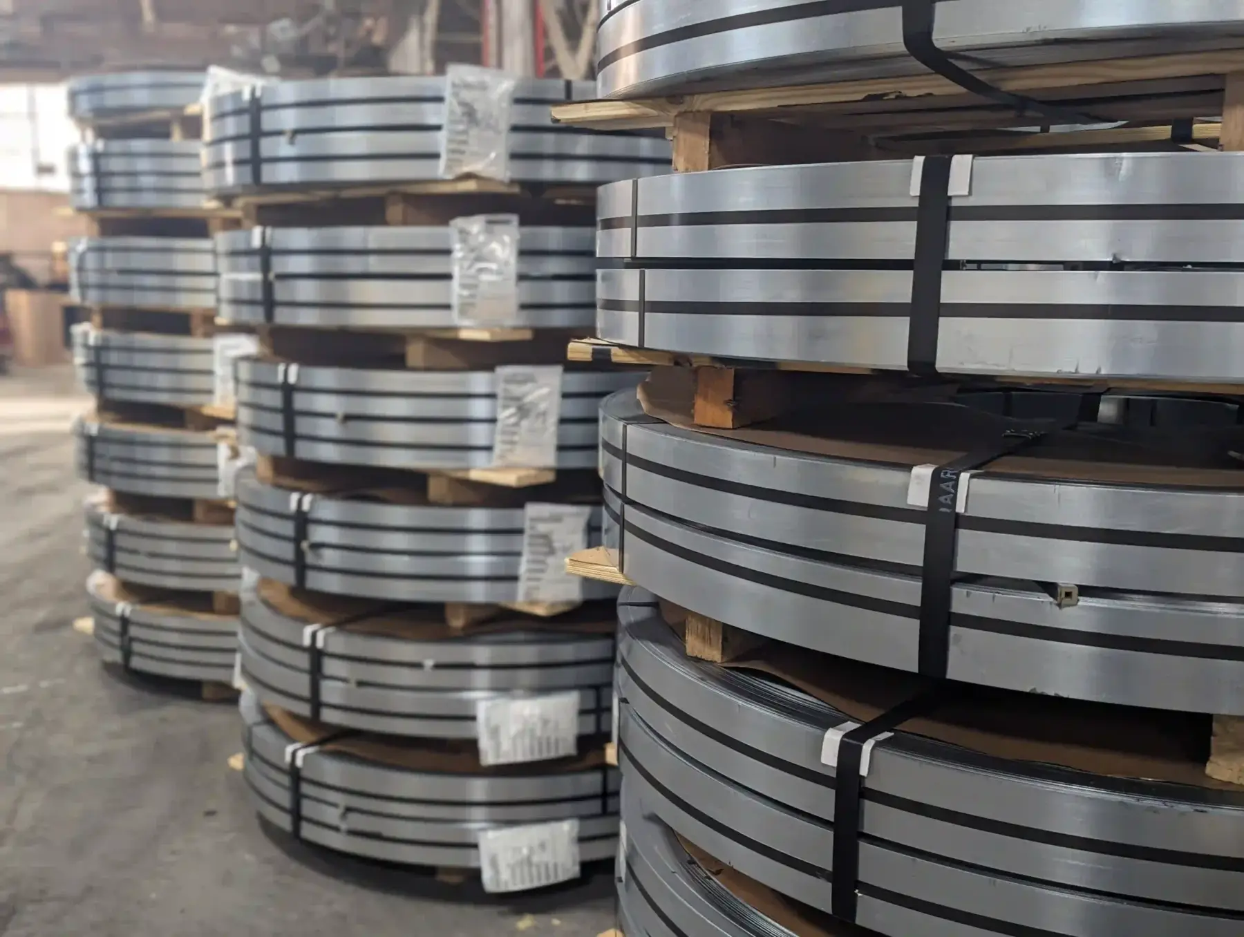 Stacks of banded slit steel coils on skids in Charter Steel Trading's Chicago warehouse