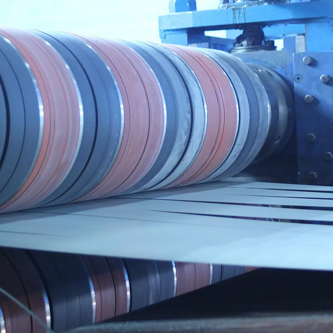 Slit steel strands separated by tooling at the recoiler of a Chicago Steel slitting line