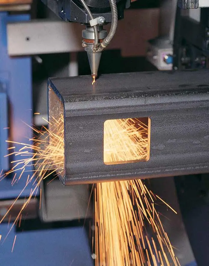 Tube laser cutting a rectangular opening in square steel tubing with a shower of sparks