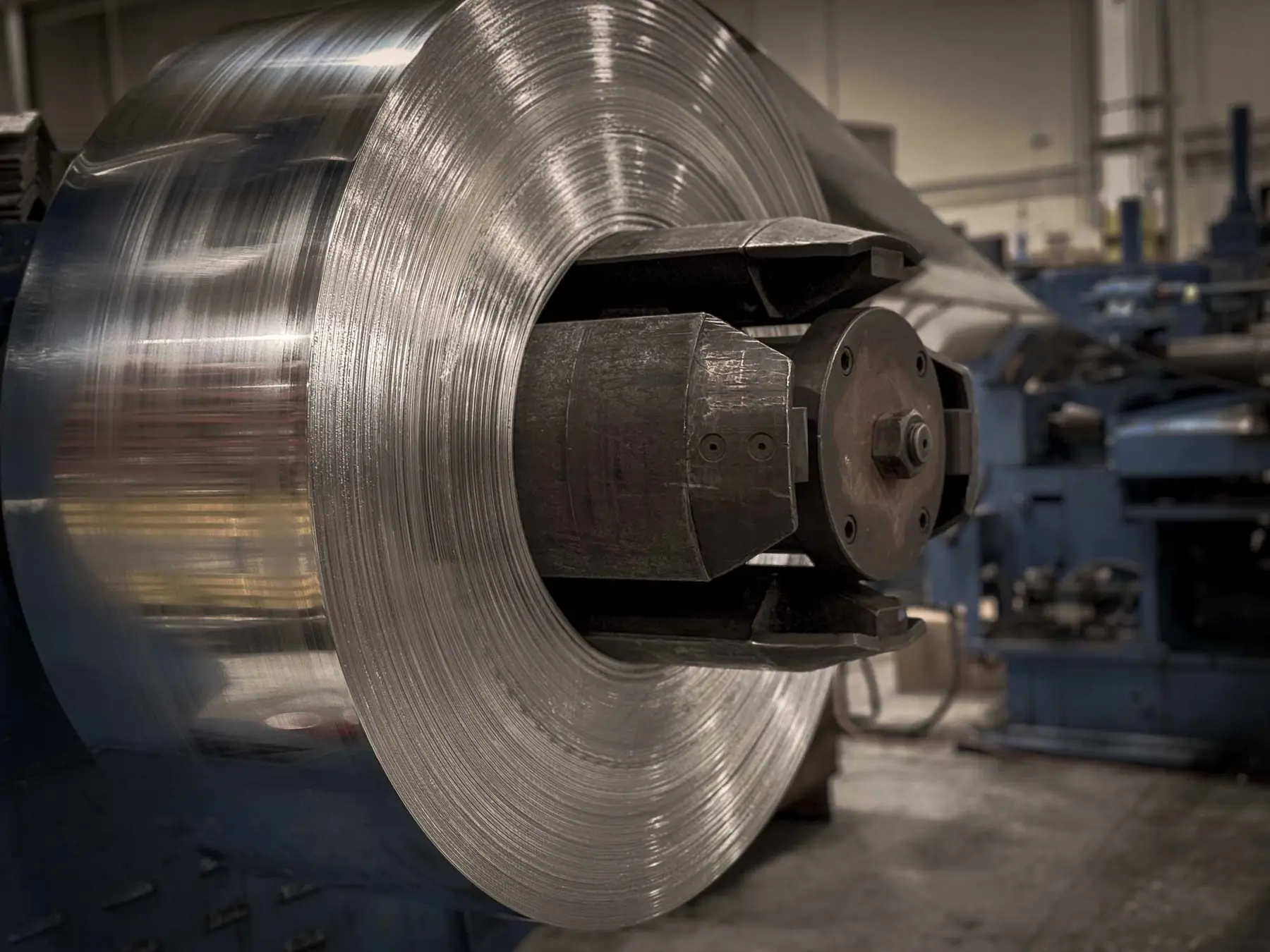 Stainless steel coil mounted on a processing line arbor at Christy Metals