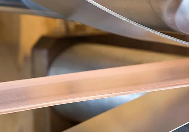 Copper clad strip running between rolls at Clad Metal Specialties