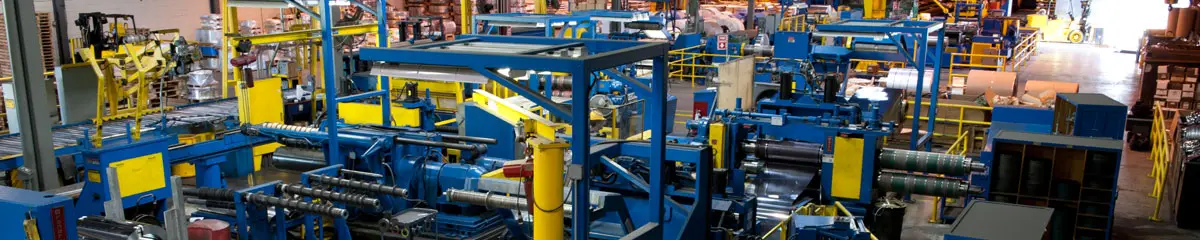 Clayton Metals' blue slitting lines and coil handling equipment on the plant floor