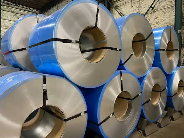 Film-wrapped metal coils stacked in the Coilplus Pennsylvania warehouse