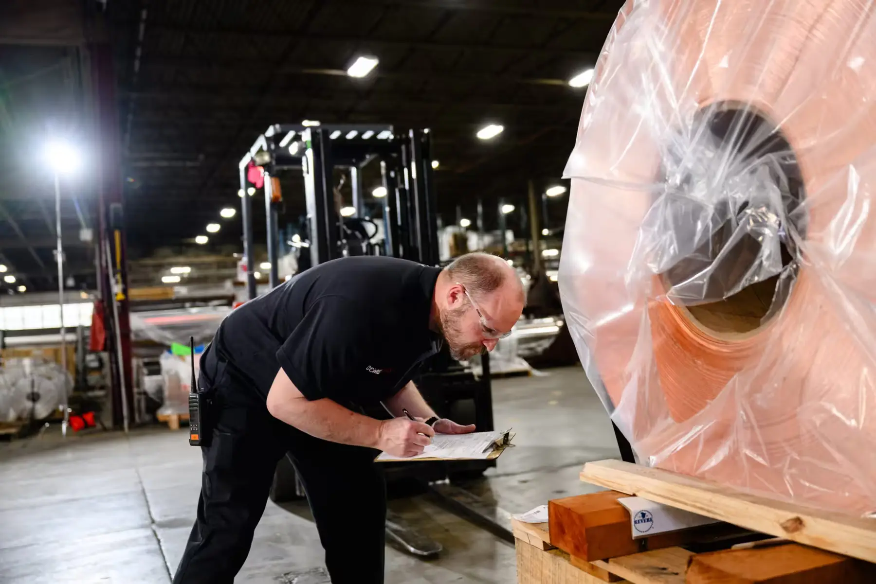 Wrapped copper coil on a skid being checked in the Comet Metals warehouse in Solon