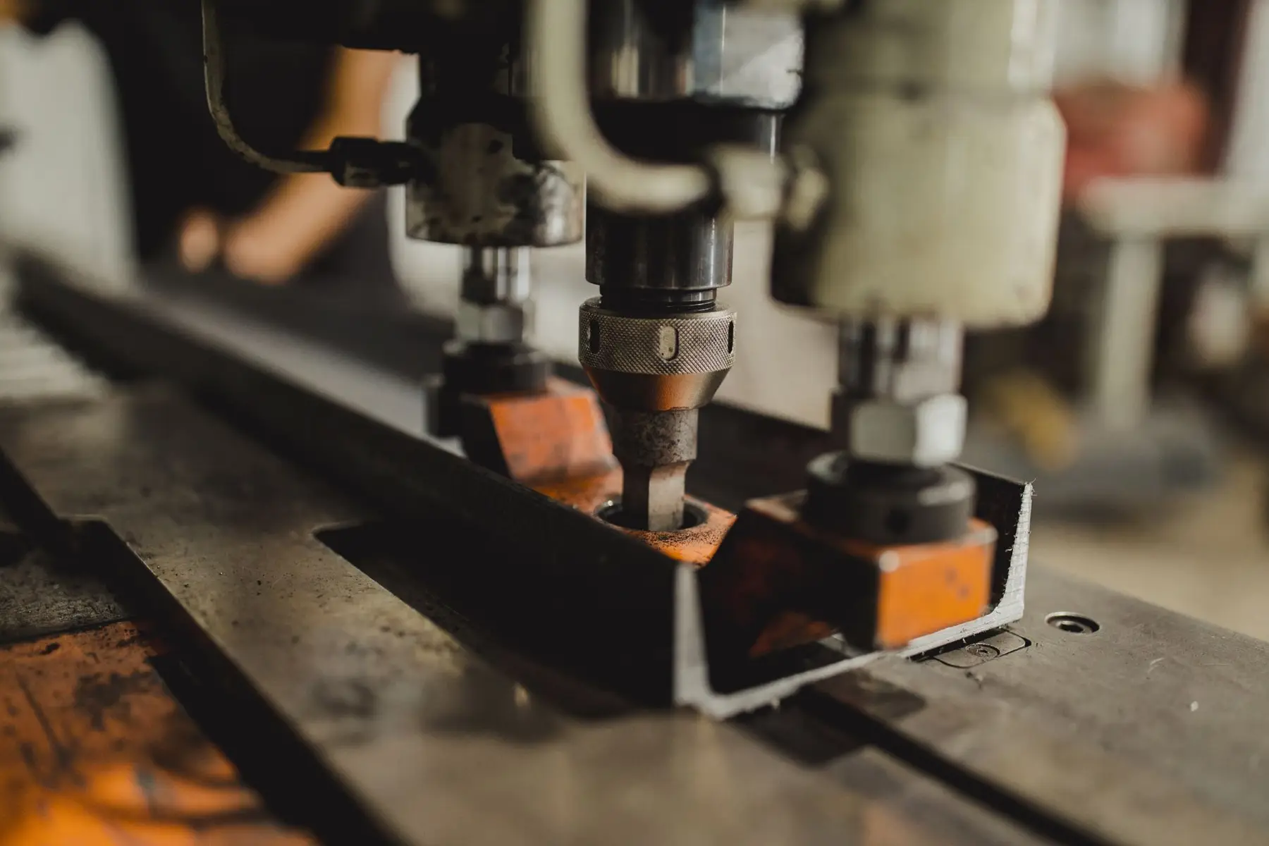 Structural punching machine punching holes in a steel angle at Coosa Steel