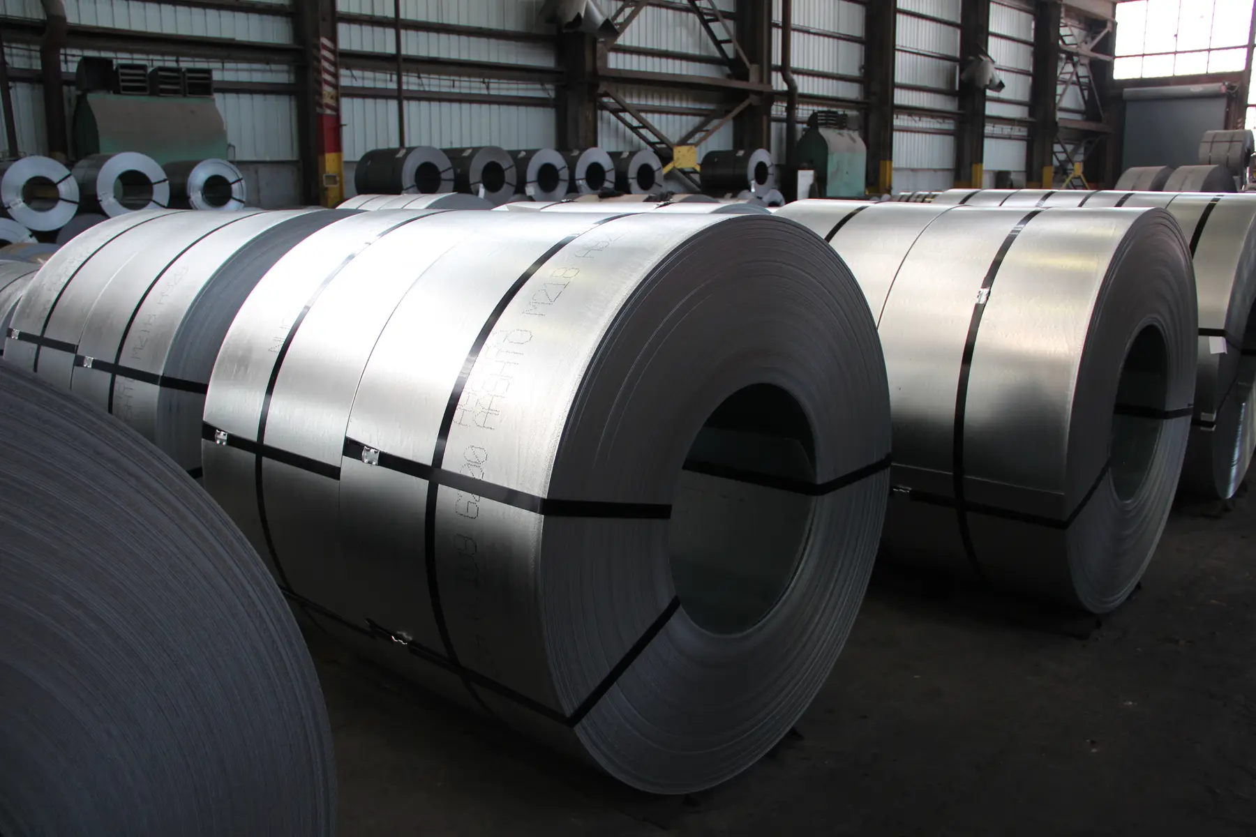 Rows of banded steel coils in Custom Steel Processing's warehouse