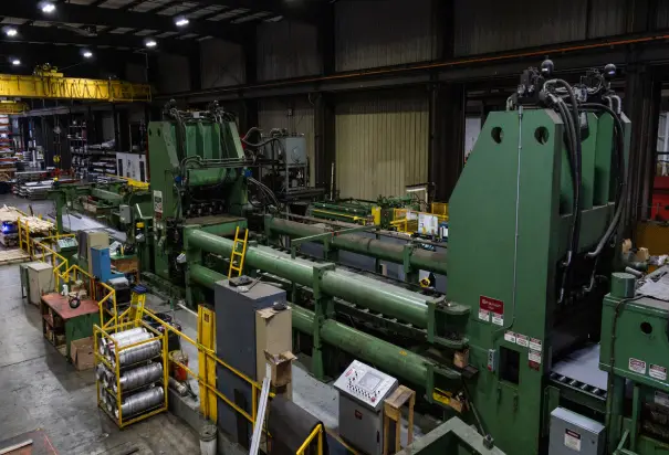 Dalco Metals' green stretcher-leveler cut-to-length line on the Walworth plant floor