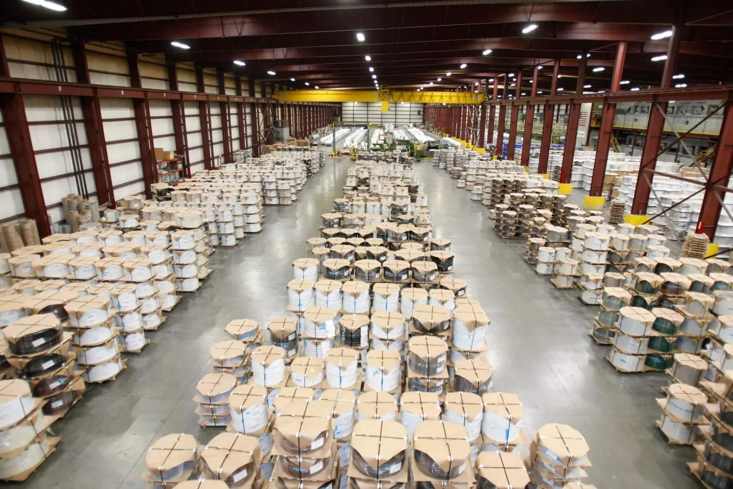 Rows of packaged coated coils stored in the EDCOAT warehouse