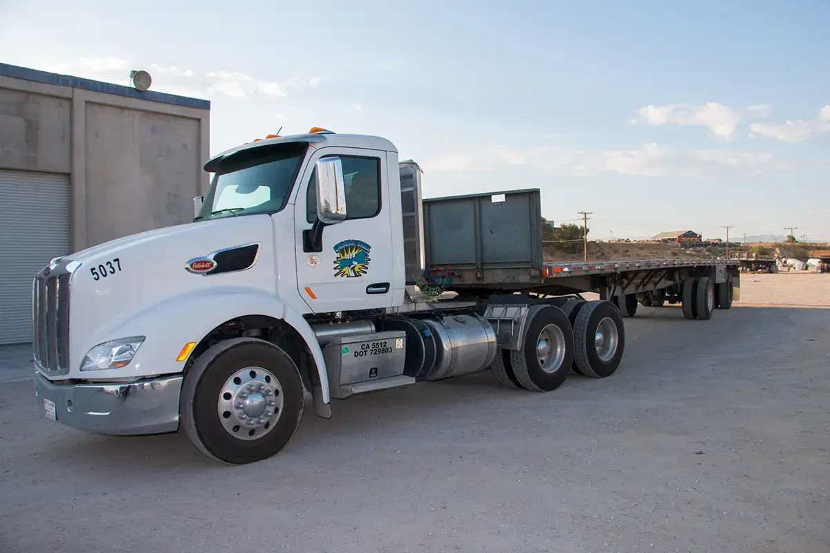 Endura Steel flatbed delivery truck parked at the yard