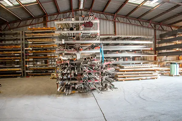 Racks of steel bar, tube and pipe inside an Endura Steel warehouse