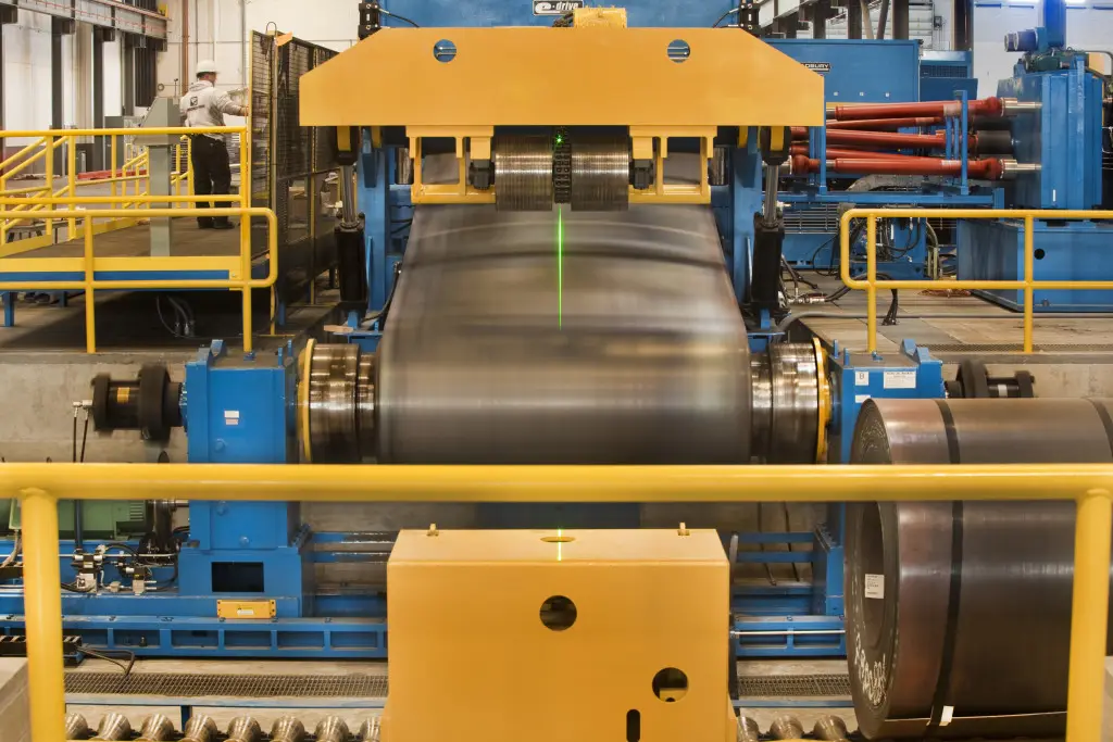 Steel coil feeding into the leveler on Farwest Steel's heavy-gauge cut-to-length line