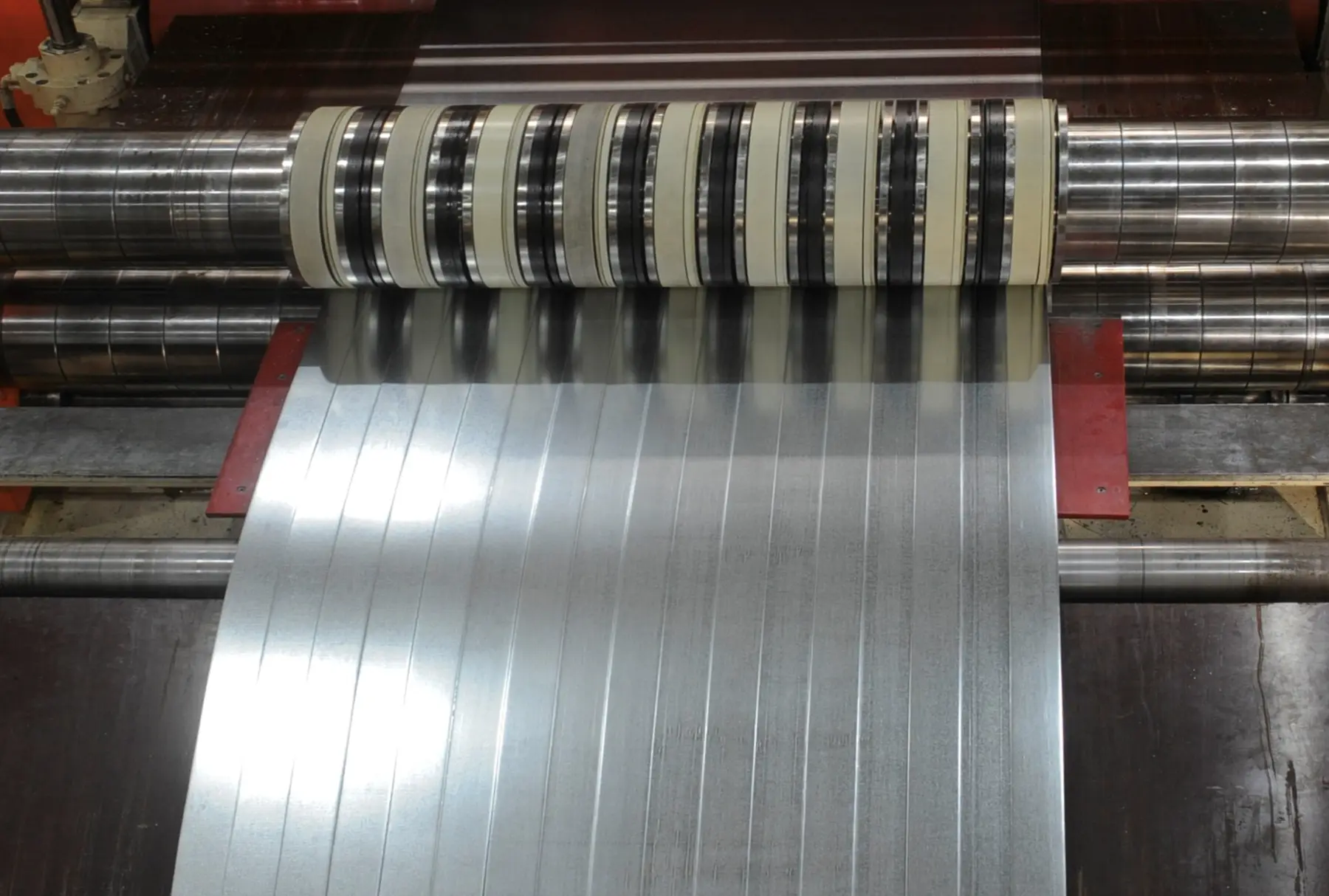 Cold-rolled strip passing through the knife arbors of Ferrous Metal Processing's CR slitter