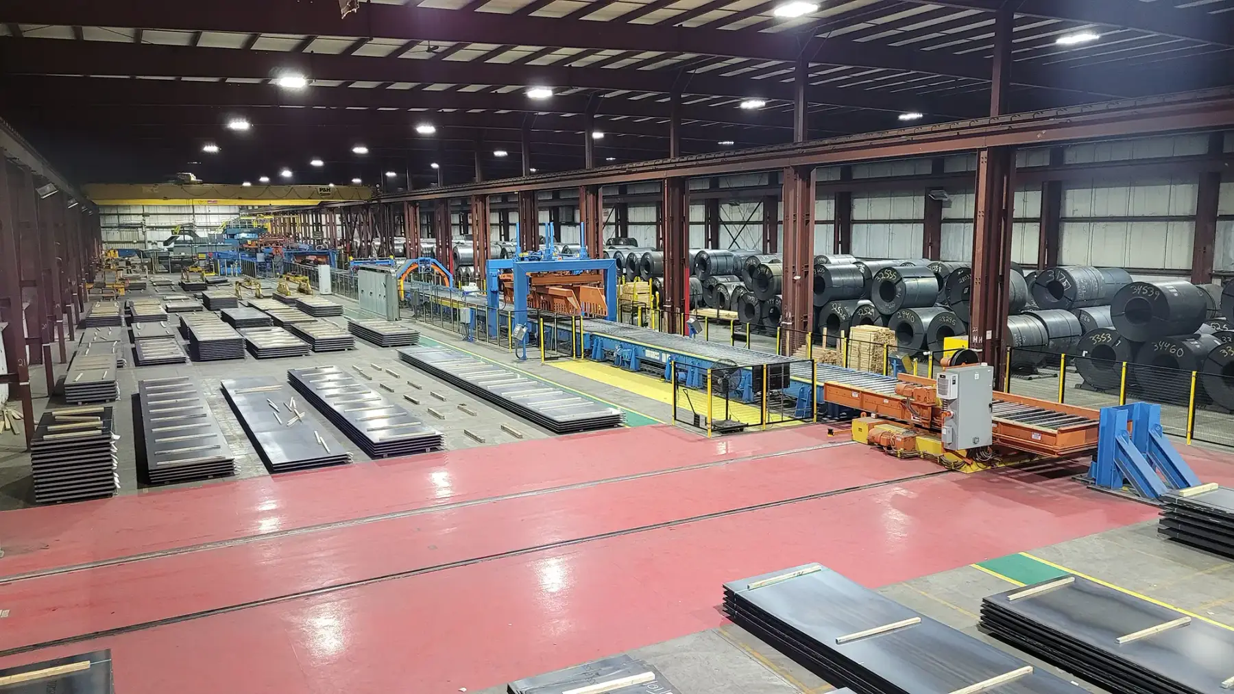 Processing line and stacks of cut steel sheet on the Granite City plant floor