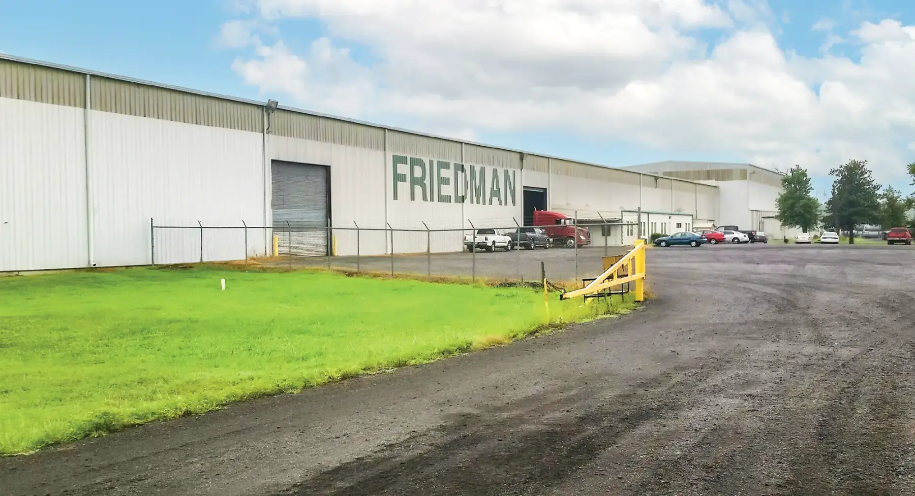 Exterior of a Friedman Industries processing plant with Friedman signage and truck yard