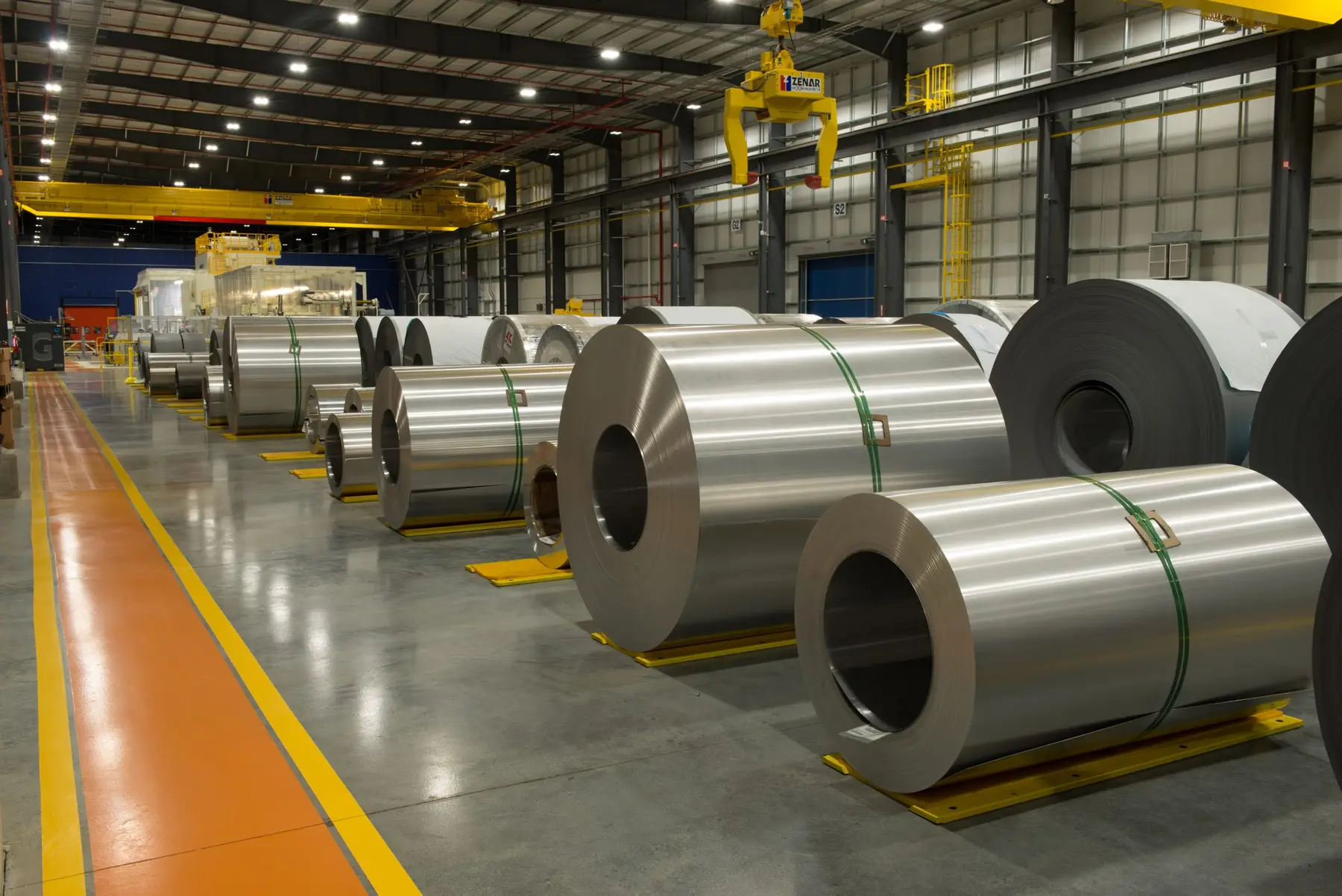 Rows of steel coils staged in the climate-controlled bay beneath overhead cranes at Georgetown Metal Processing