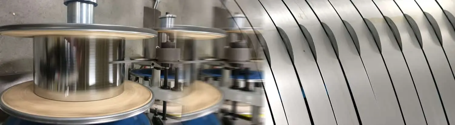 Precision slit stainless strip and oscillate-wound spools on a Gibbs Interwire winding line