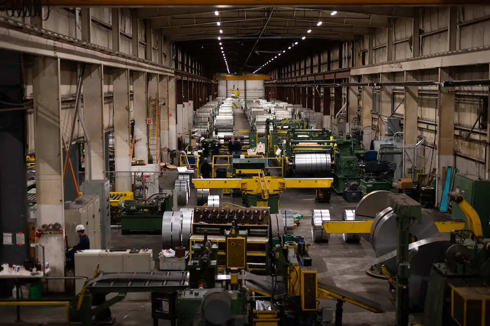 Coil processing lines running down the length of a Grand Steel plant bay