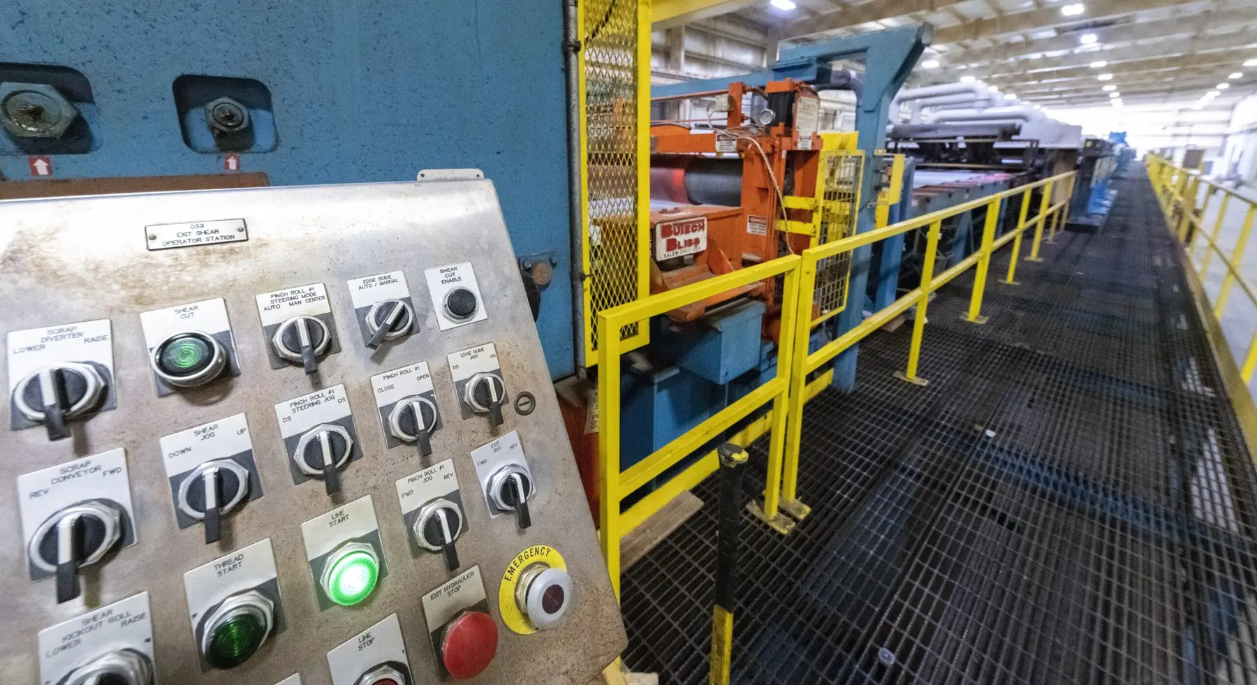 Pickle line control panel beside an elevated walkway along the line