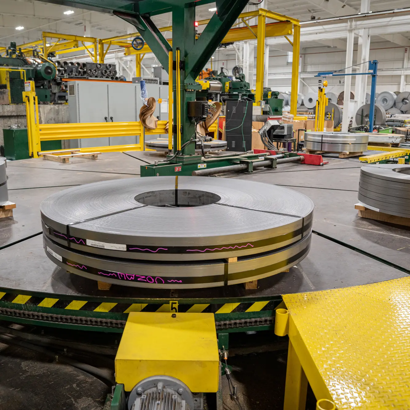 Freshly slit steel coil on the exit turnstile of a Greenpoint Metals slitting line