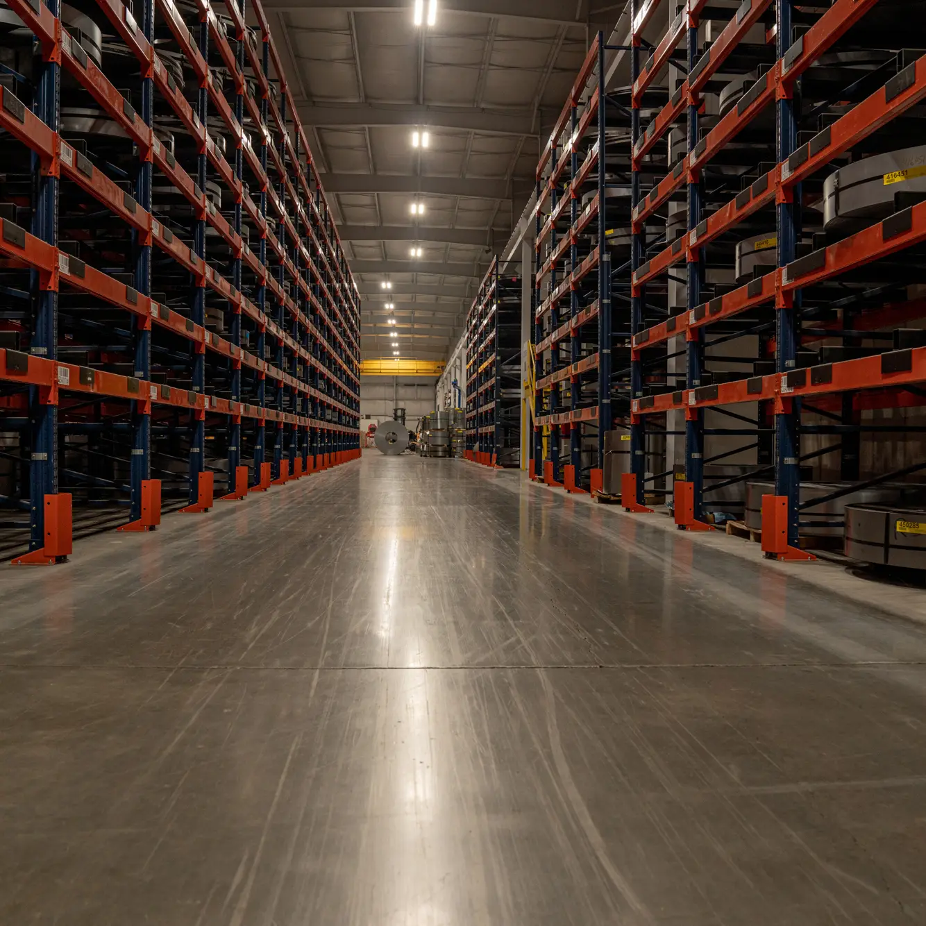 Long aisle of steel racking in Greenpoint Metals' climate-controlled warehouse