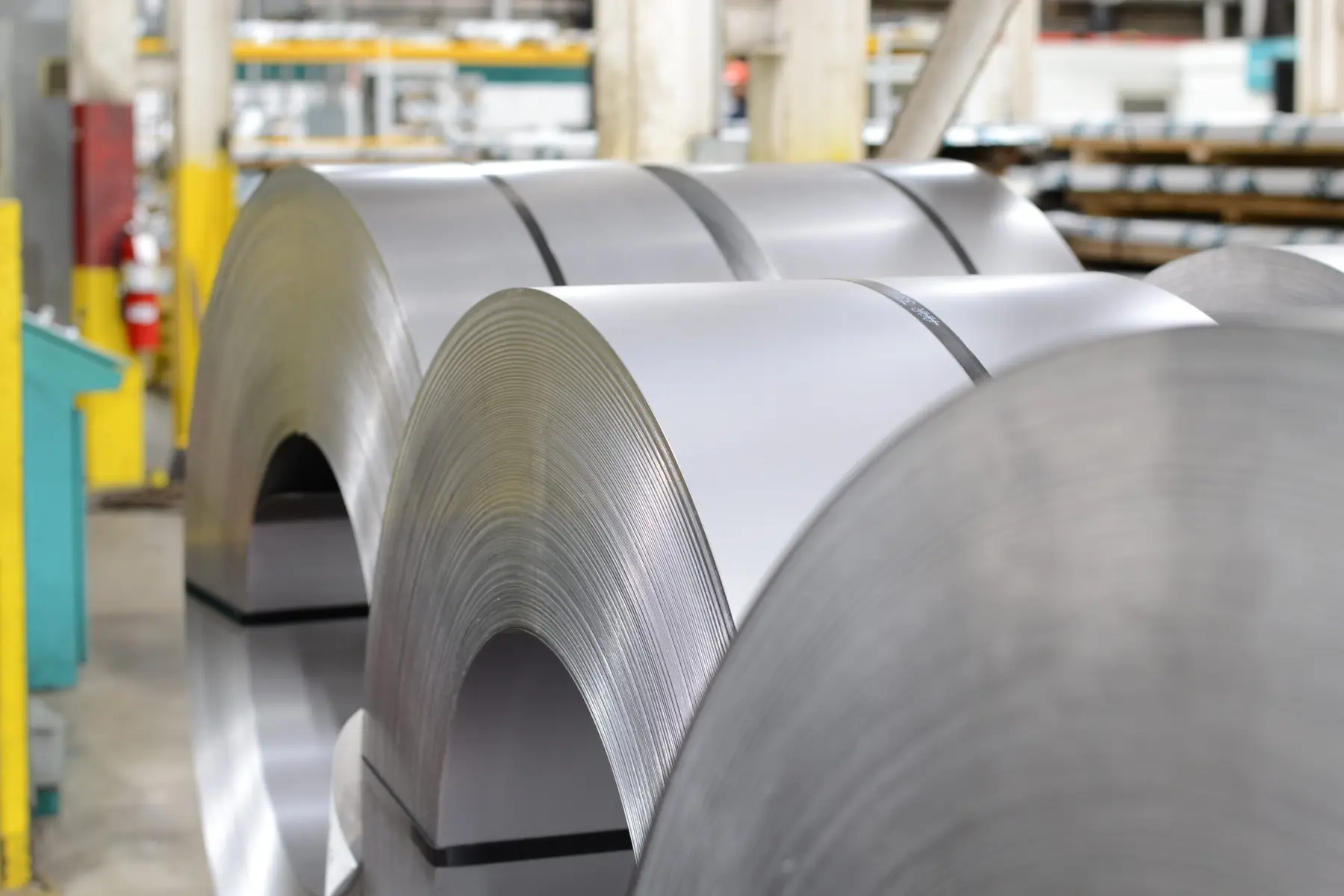 Bright steel coils staged on the floor of H&H Metal Source's Grand Rapids plant