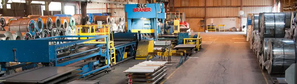 Braner processing line and rows of steel coils on the Harbor Pipe & Steel plant floor in Riverside