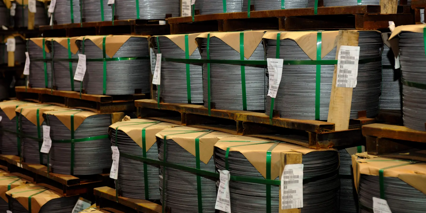 Stacks of packaged steel blanks banded and tagged for shipment in the warehouse