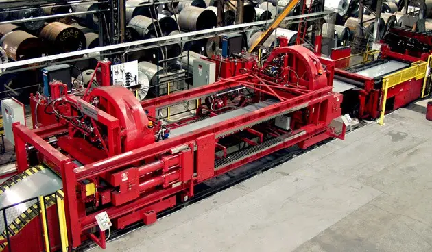 Red cut-to-length line with leveler and coil inventory at JDM Steel in Chicago Heights