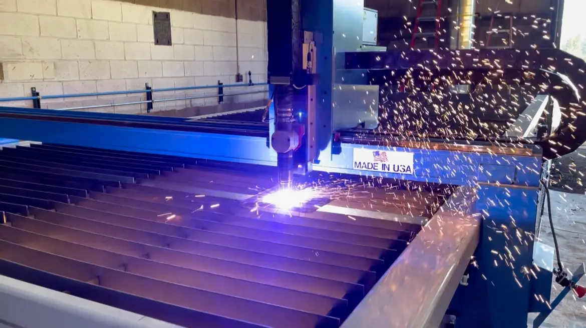 Plasma torch cutting steel plate on a cutting table
