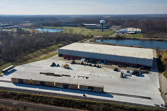 Aerial view of a King Steel warehouse with steel inventory staged in the yard