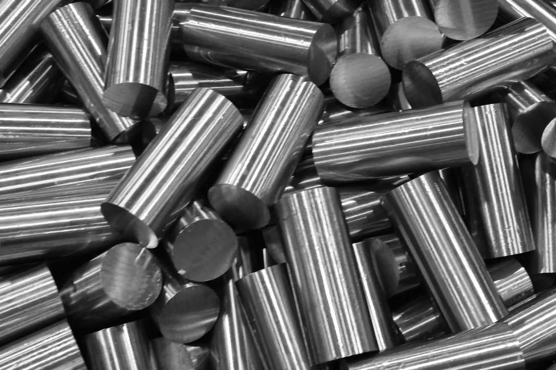 Pile of saw-cut steel bar blanks with machined ends