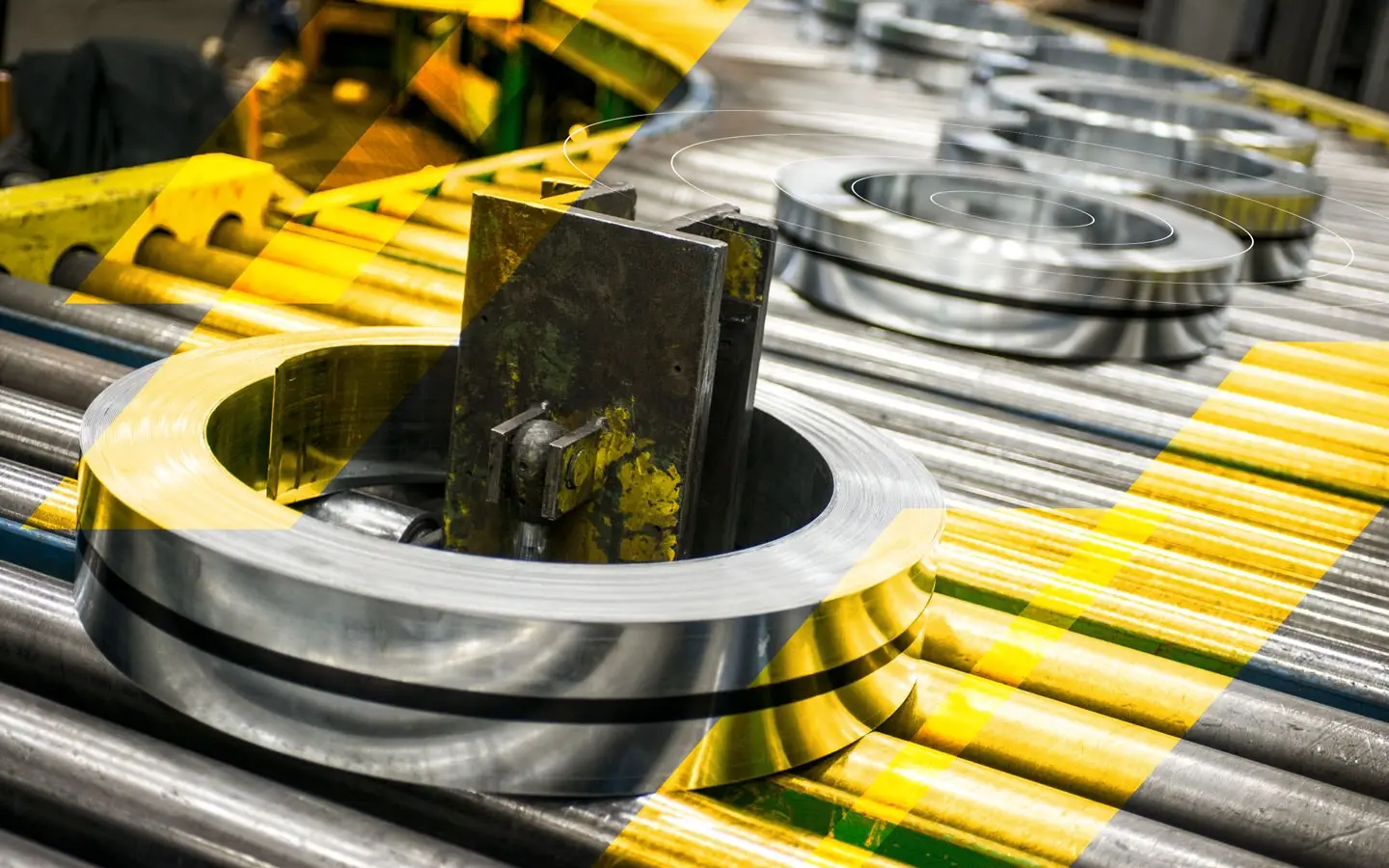Finished slit steel coils moving along a roller conveyor at Koil
