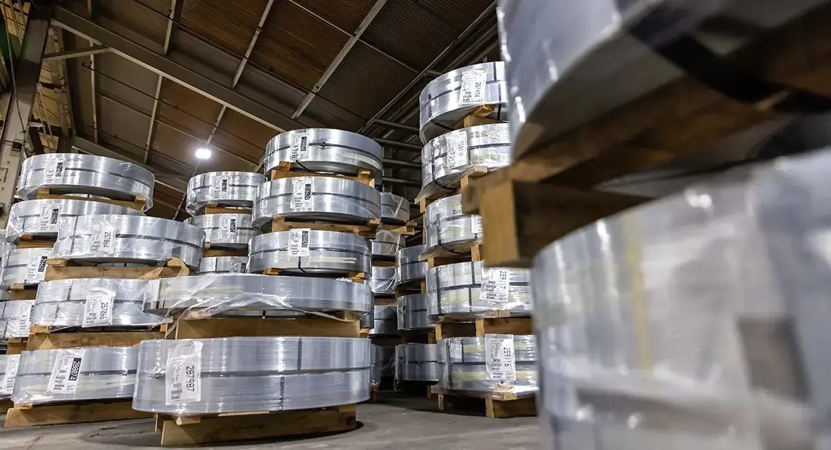 Stacks of slit steel coils on pallets in the Lane Steel warehouse