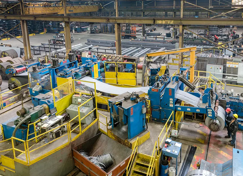 Liebovich's 72-inch slitting line with blue and yellow coil handling equipment on the plant floor