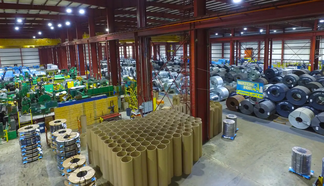 Elevated view of the Magic Coil Products plant floor in Butler with processing lines, steel coils and slit coil stacks